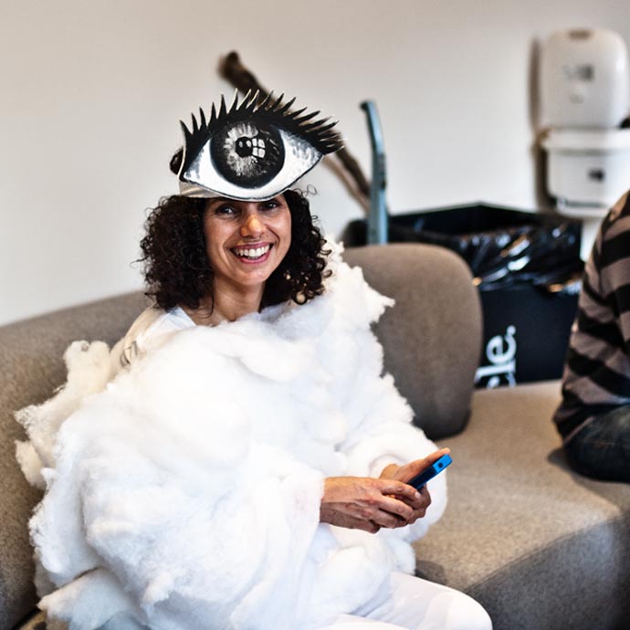 Halloween iCloud costume of a fluffy “cloud” dress and a hat with a large eyeball.