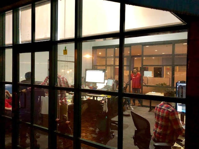 Evening view of Digital Foundry’s office from outside the glass wall.