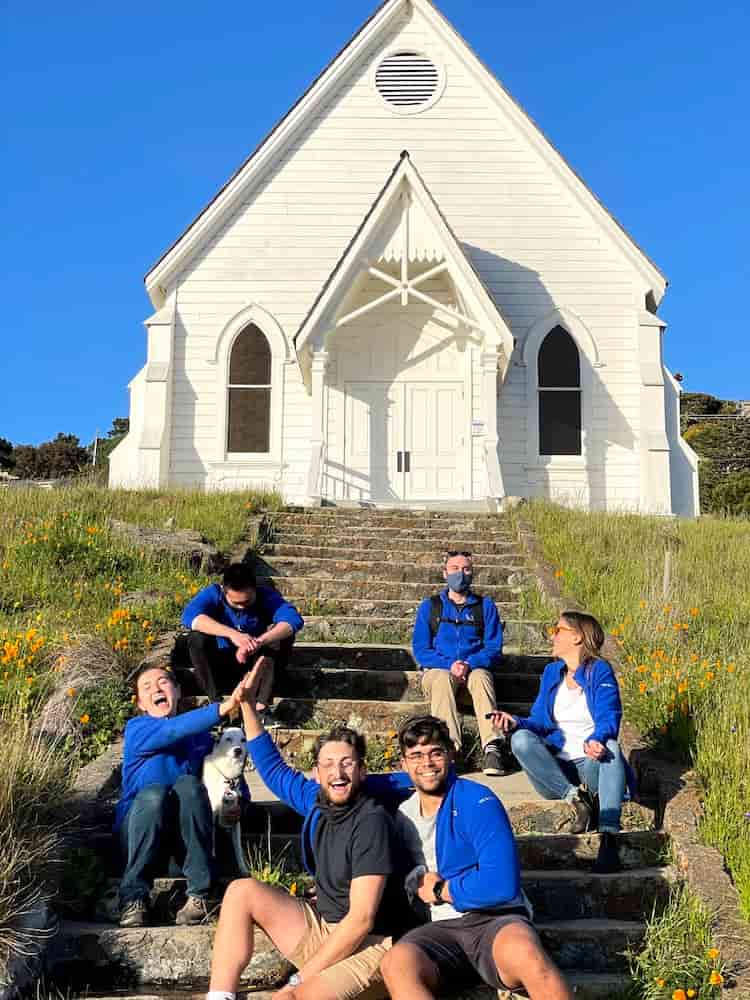 Group in matching blue Digital Foundry fleece jackets in front of St. Hilary’s church in Tiburon.