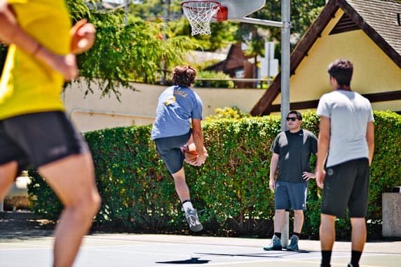 Trying an under-the-leg trick basketball shot.