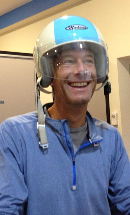 Man smiling in a scooter helmet.