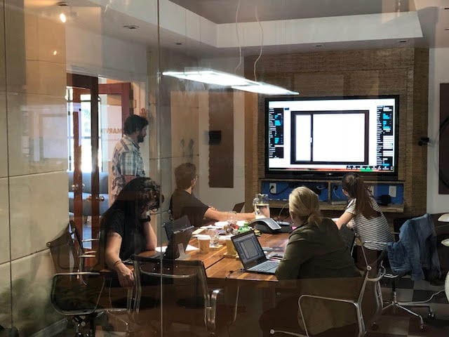 Presentation on a large screen in the Crucible meeting room.