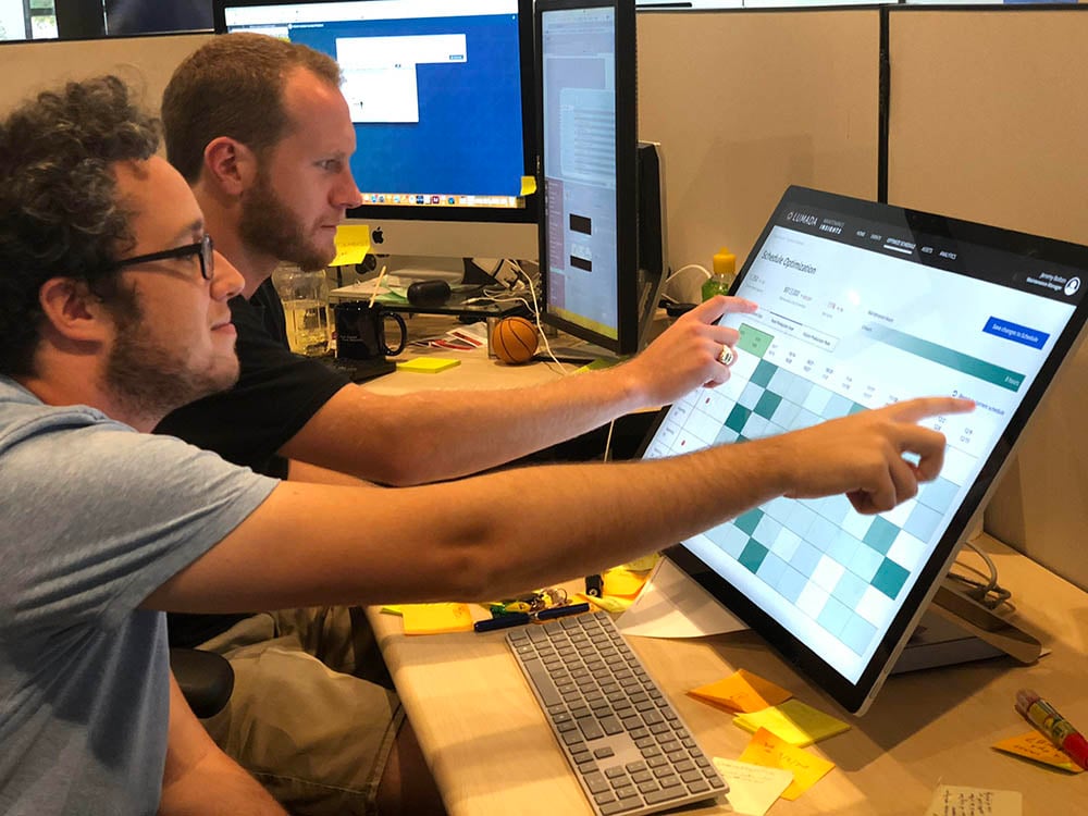 Demonstrating custom software on a Microsoft Surface Studio all-in-one.