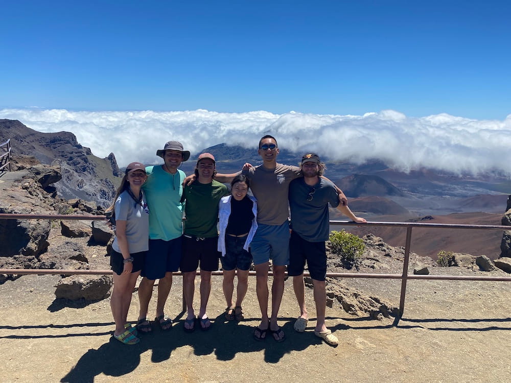 Six hikers at the top of Haleakala volcano.